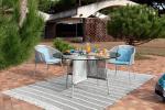 Roche-bobois-traveler-outdoor-round-table-in-metal-and-glass-in-garden